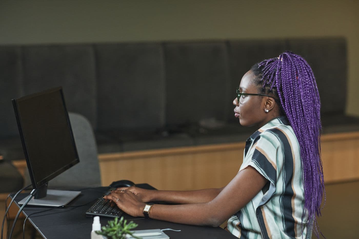 A developer focused on work at a desktop computer
