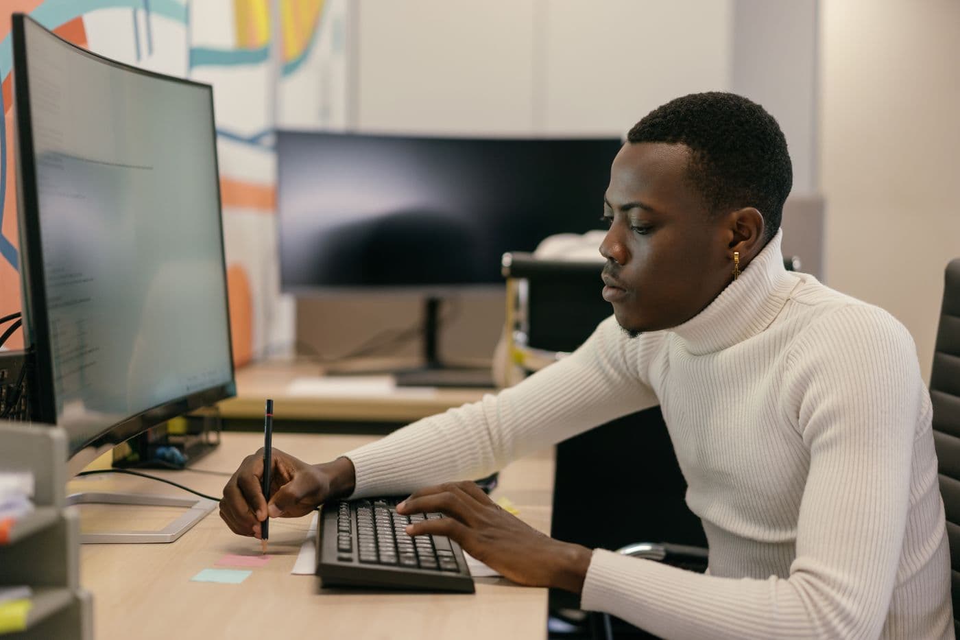 A developer focused on code at a desk
