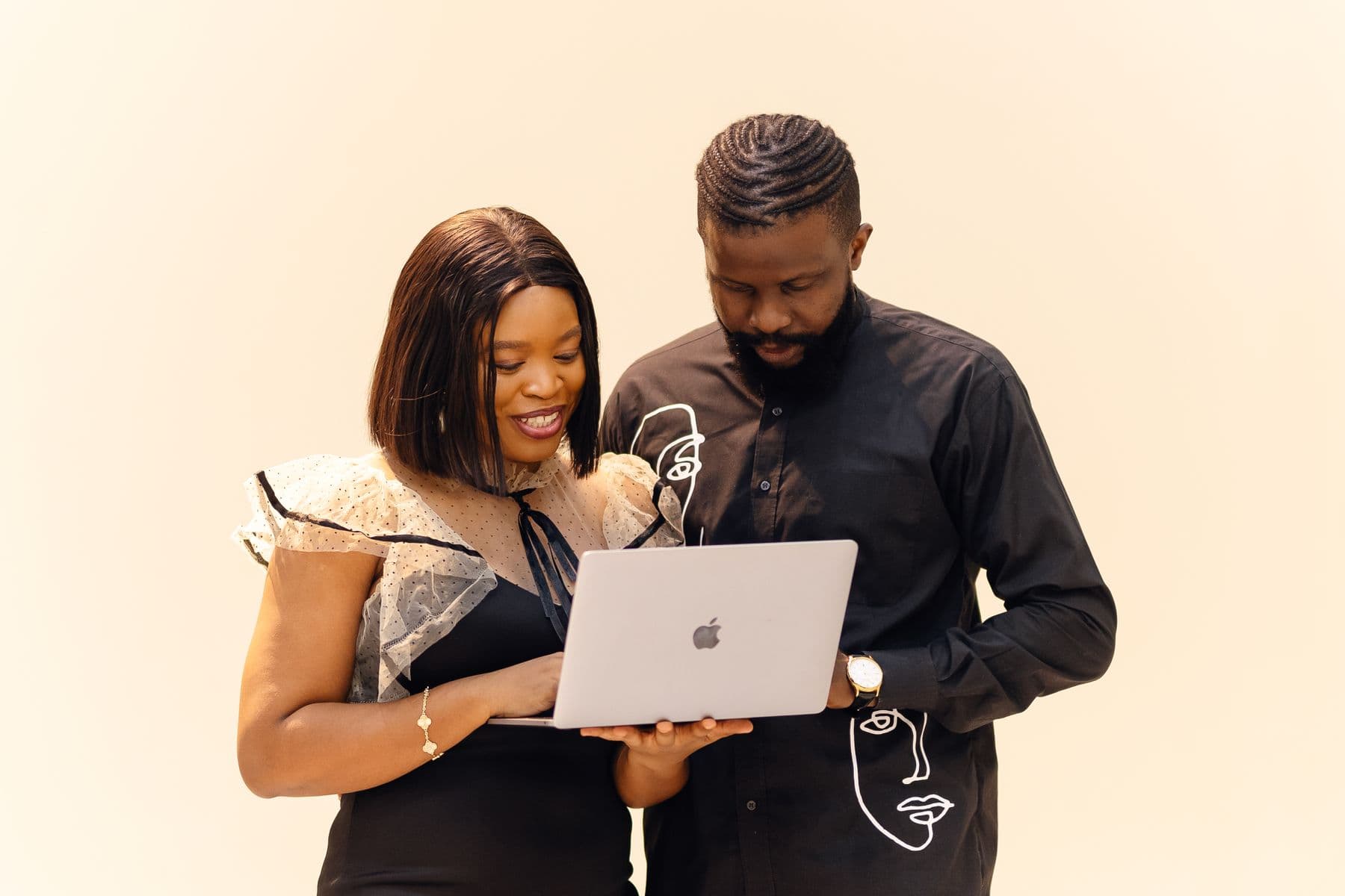 Two colleagues reviewing work together on a laptop