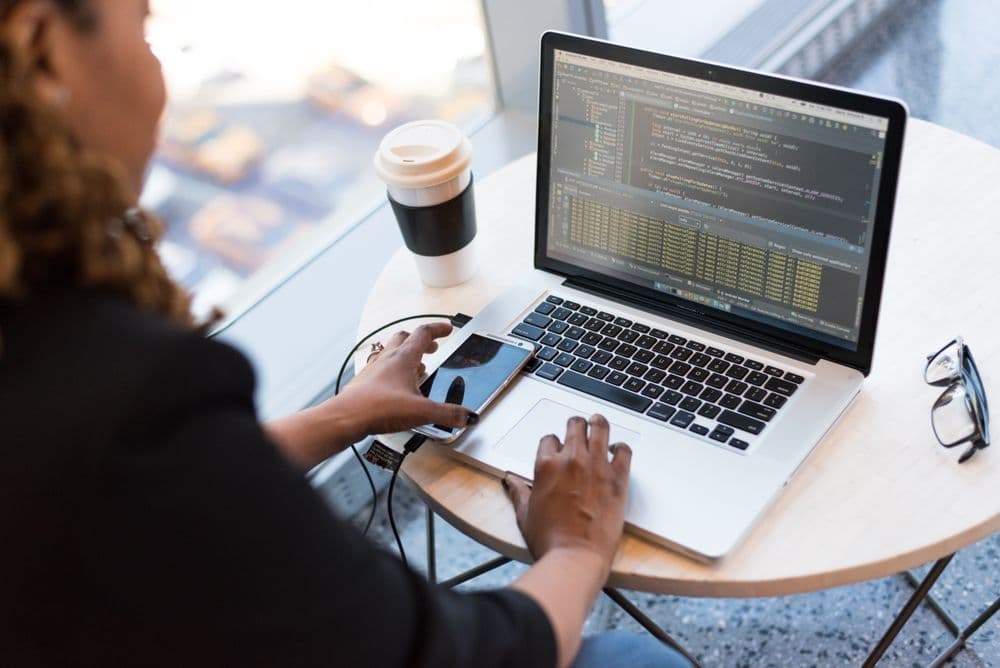 A developer working through code on a laptop